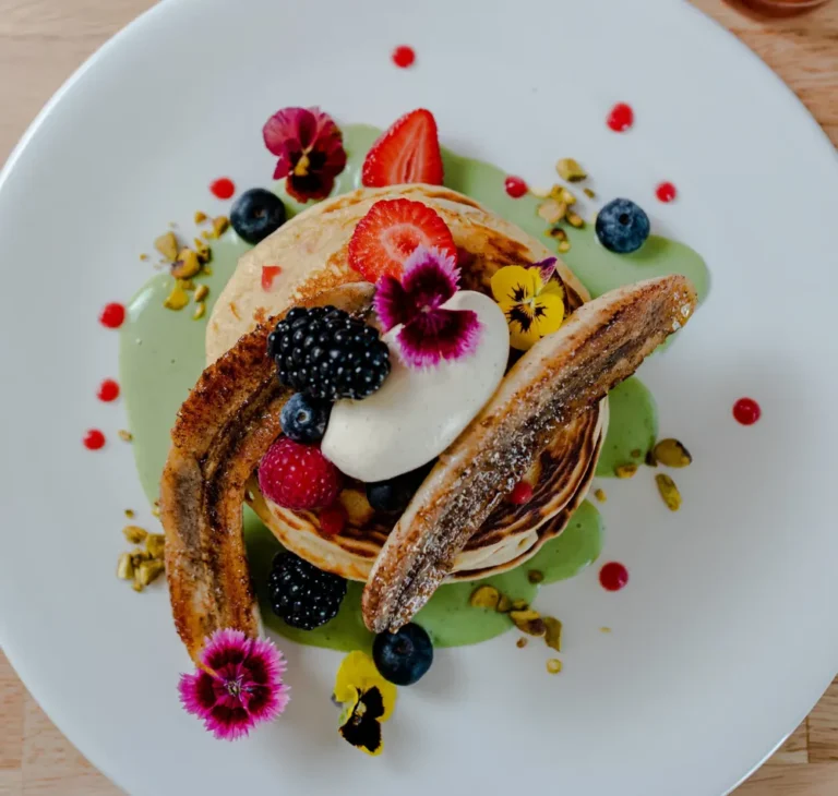 Banana pancakes with caramelised banana, berries, vanilla cream and pistachio crème anglaise at Mimosa Subiaco